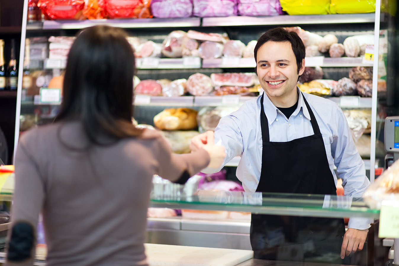 woman giving ticket to a butcher